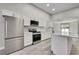 Kitchen with stainless steel appliances, island, and white cabinets at 4360 Talco Ave, Spring Hill, FL 34609