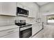 Kitchen with stainless steel appliances, island, and white cabinets at 4360 Talco Ave, Spring Hill, FL 34609