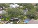 Aerial view of a house with a boat dock and pool in a residential neighborhood at 4439 Reeves Rd, New Port Richey, FL 34652