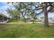 Sprawling backyard with mature trees, lush lawn, and access to the water at 4439 Reeves Rd, New Port Richey, FL 34652