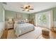 Spacious bedroom features french doors, bright window and a ceiling fan at 4439 Reeves Rd, New Port Richey, FL 34652