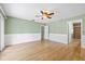 Large bedroom with ensuite bath, hardwood floors, wainscoting, and ample space for versatile use at 4439 Reeves Rd, New Port Richey, FL 34652