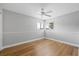 Bedroom with neutral walls, wood floor, a ceiling fan, and a window at 4439 Reeves Rd, New Port Richey, FL 34652