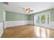 Bedroom with wainscotting and sliding glass doors leading to a balcony at 4439 Reeves Rd, New Port Richey, FL 34652