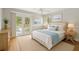 Bright bedroom featuring a private balcony, neutral decor, and ample natural light for a tranquil retreat at 4439 Reeves Rd, New Port Richey, FL 34652