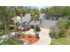 Beautiful two-story home featuring lush landscaping, a circular driveway, and a two-car garage at 4439 Reeves Rd, New Port Richey, FL 34652