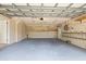 Spacious garage with painted floors, utility sink, and storage racks provides ample space for vehicles and projects at 4439 Reeves Rd, New Port Richey, FL 34652