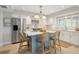 Bright kitchen with stainless steel appliances and island with barstool seating at 4439 Reeves Rd, New Port Richey, FL 34652