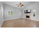 Spacious living room with wood floors, vaulted ceilings, fireplace, and abundant natural light at 4439 Reeves Rd, New Port Richey, FL 34652