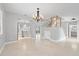 Elegant open-concept living area with staircase views and seamless flow to the kitchen at 4439 Reeves Rd, New Port Richey, FL 34652