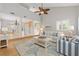 Bright living room boasts vaulted ceilings, coastal decor, and an open layout to the kitchen and staircase at 4439 Reeves Rd, New Port Richey, FL 34652