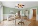 Inviting home office with sage green walls, wainscoting, and ample natural light, creating a productive workspace at 4439 Reeves Rd, New Port Richey, FL 34652