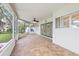 Enjoy the outdoors from this screened patio with ceiling fan and tile flooring, perfect for entertaining at 4439 Reeves Rd, New Port Richey, FL 34652