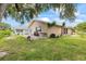 A shot of the backyard featuring a small patio, grill, and a lush yard at 4543 Dewey Dr, New Port Richey, FL 34652