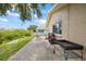 Outdoor patio with grill and adjacent landscaping near the water's edge at 4543 Dewey Dr, New Port Richey, FL 34652