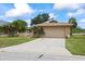 Charming single-story home featuring a two-car garage, lush landscaping, and a spacious driveway at 4543 Dewey Dr, New Port Richey, FL 34652