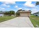 Charming single-story home featuring a two-car garage, lush landscaping, and a spacious driveway at 4543 Dewey Dr, New Port Richey, FL 34652