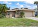 Attractive single-story home with a two-car garage and manicured landscaping around the property at 4543 Dewey Dr, New Port Richey, FL 34652