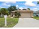 Inviting single-story home with a well-maintained lawn, two-car garage, and convenient mailbox at 4543 Dewey Dr, New Port Richey, FL 34652