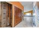 Hallway in a renovation project showcasing framing, tiled floor, and orange walls at 4543 Dewey Dr, New Port Richey, FL 34652