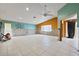 Bright living room featuring tiled floors, ceiling fan, and partially renovated walls at 4543 Dewey Dr, New Port Richey, FL 34652