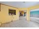 Living space under renovation, showing tiled floors and open doorway to other rooms at 4543 Dewey Dr, New Port Richey, FL 34652