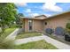 A close up side exterior shot featuring a side door, an air conditioner, and a nice walkway at 4543 Dewey Dr, New Port Richey, FL 34652