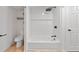 Clean white bathroom features tile shower with a built-in niche, and modern fixtures at 4622 Paloverde Dr, New Port Richey, FL 34652
