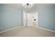 Bedroom showing carpet flooring, blue walls and multiple doors at 4622 Paloverde Dr, New Port Richey, FL 34652