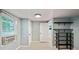 Bright bedroom showcasing two doors, a window, wall shelves and neutral carpet flooring at 4622 Paloverde Dr, New Port Richey, FL 34652