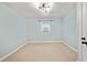 Bright bedroom features neutral carpet, a window unit, and a stylish modern ceiling light at 4622 Paloverde Dr, New Port Richey, FL 34652