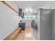 Modern kitchen featuring butcher block countertops, stainless steel appliances, a long wooden bench, and stylish fixtures at 4622 Paloverde Dr, New Port Richey, FL 34652