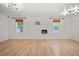 Bright living room with wood-look floors, two windows, and stylish modern lighting at 4622 Paloverde Dr, New Port Richey, FL 34652