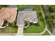 A bird's eye view captures the home's roof, landscaping, lawn, driveway, and neighborhood street at 5072 Abbonmarsh Cir, Brooksville, FL 34604