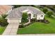 An aerial shot highlights this property's inviting front yard, two-car garage, and manicured landscaping at 5072 Abbonmarsh Cir, Brooksville, FL 34604