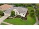 An aerial view showcases this home's landscaping, well-maintained lawn, and the proximity to lush green trees at 5072 Abbonmarsh Cir, Brooksville, FL 34604