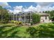 Well maintained lawn and garden area with the screened in pool area in the background at 5072 Abbonmarsh Cir, Brooksville, FL 34604