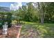 A well maintained backyard featuring mature trees, landscaping, and screened-in lanai at 5072 Abbonmarsh Cir, Brooksville, FL 34604