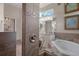 Bathroom features a glass shower, a jacuzzi tub, and double sink vanity with marble countertop at 5072 Abbonmarsh Cir, Brooksville, FL 34604