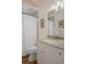 Bright bathroom featuring a granite countertop, large mirror, and tiled shower with shower curtain at 5072 Abbonmarsh Cir, Brooksville, FL 34604