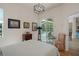 Bedroom with a slider door to a pool area, a light fixture, and wood floors at 5072 Abbonmarsh Cir, Brooksville, FL 34604