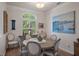 Cozy dining room featuring a round table, shuttered window, and elegant decor at 5072 Abbonmarsh Cir, Brooksville, FL 34604