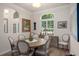 Bright dining room showcases natural light from shuttered window and stylish decor with seating for six at 5072 Abbonmarsh Cir, Brooksville, FL 34604
