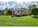 Well-maintained home with lush landscaping surrounding the perimeter, offering a serene curb appeal at 5072 Abbonmarsh Cir, Brooksville, FL 34604