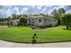 Well-maintained home with lush landscaping surrounding the perimeter, offering a serene curb appeal at 5072 Abbonmarsh Cir, Brooksville, FL 34604