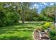 A well maintained front lawn featuring mature trees and landscaping at 5072 Abbonmarsh Cir, Brooksville, FL 34604