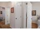 Bright hallway with wood floors, neutral walls and white doors create a clean, open feel at 5072 Abbonmarsh Cir, Brooksville, FL 34604
