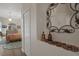 Hallway with a decorative mirror and view of a bedroom at 5072 Abbonmarsh Cir, Brooksville, FL 34604