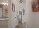Hallway view into bathroom with granite counters and view into bright office at 5072 Abbonmarsh Cir, Brooksville, FL 34604