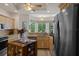 Spacious kitchen boasting wooden cabinets, stainless steel fridge, granite countertops, and lots of natural light at 5072 Abbonmarsh Cir, Brooksville, FL 34604
